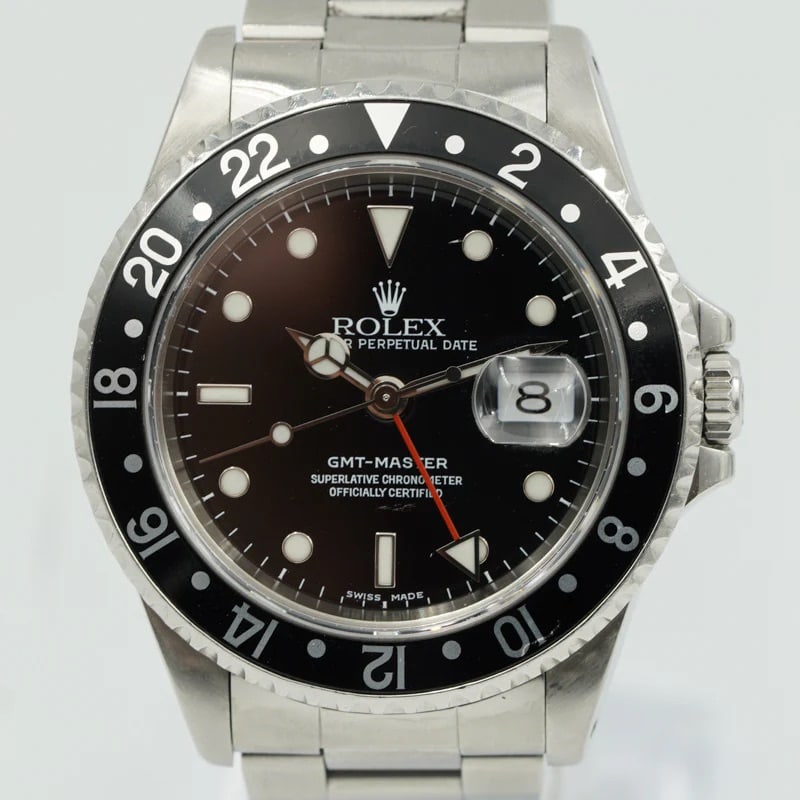1999 Rolex GMT-Master Ref 16700 Black Dial Oyster Bracelet With Papers: 1999 Rolex GMT-Master Ref 16700 Black Dial Oyster Bracelet With Papers This Rolex GMT-Master features a black dial and black bezel, paired with the classic Oyster bracelet. The timepiece is a men's mo