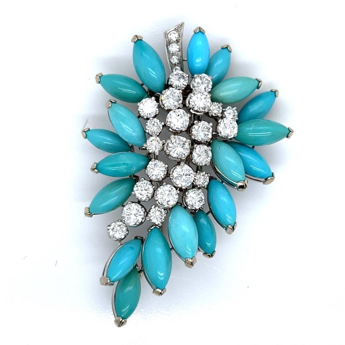 1960s 18K White Gold Persian Turquoise Diamond Brooch 27 Diamonds: 1960s 18K White Gold Persian Turquoise Diamond Brooch 27 Diamonds This exquisite 1960's brooch is crafted from 18K white gold, featuring a stunning arrangement of Persian turquoise and 27 sparkling di