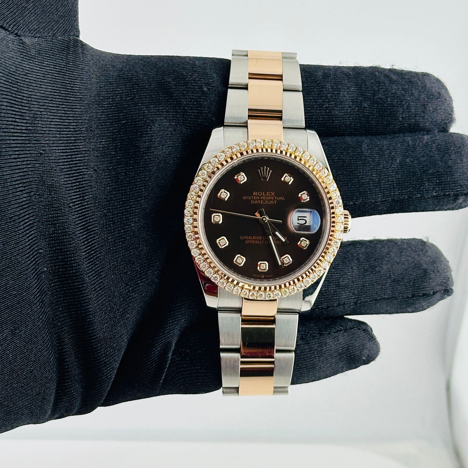 Rolex Datejust 126301 Aftermarket Diamond Chocolate Dial Oyster Bracelet: Rolex Datejust 126301 Aftermarket Diamond Chocolate Dial Oyster Bracelet This Rolex Datejust watch features a men's design with an Aftermarket chocolate diamond dial and a prong diamond bezel. The wat