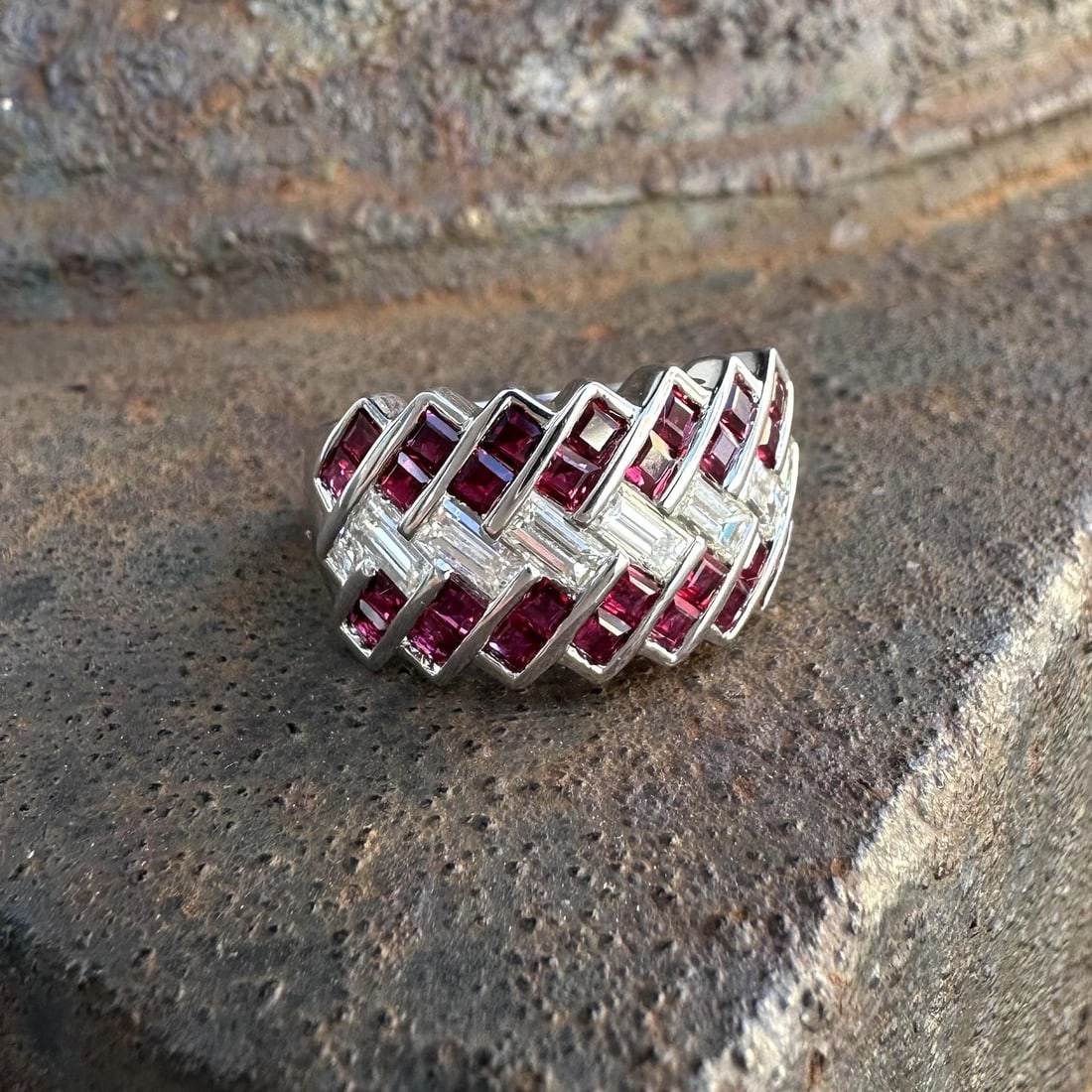 Wide Zig Zag 18k White Gold Band Ring With Square Rubies and Baguette Diamonds: Wide Zig Zag 18k White Gold Band Ring With Square Rubies and Baguette Diamonds This wide zig zag band ring is crafted from solid 18k white gold and features 28 natural square step cut rubies, totaling