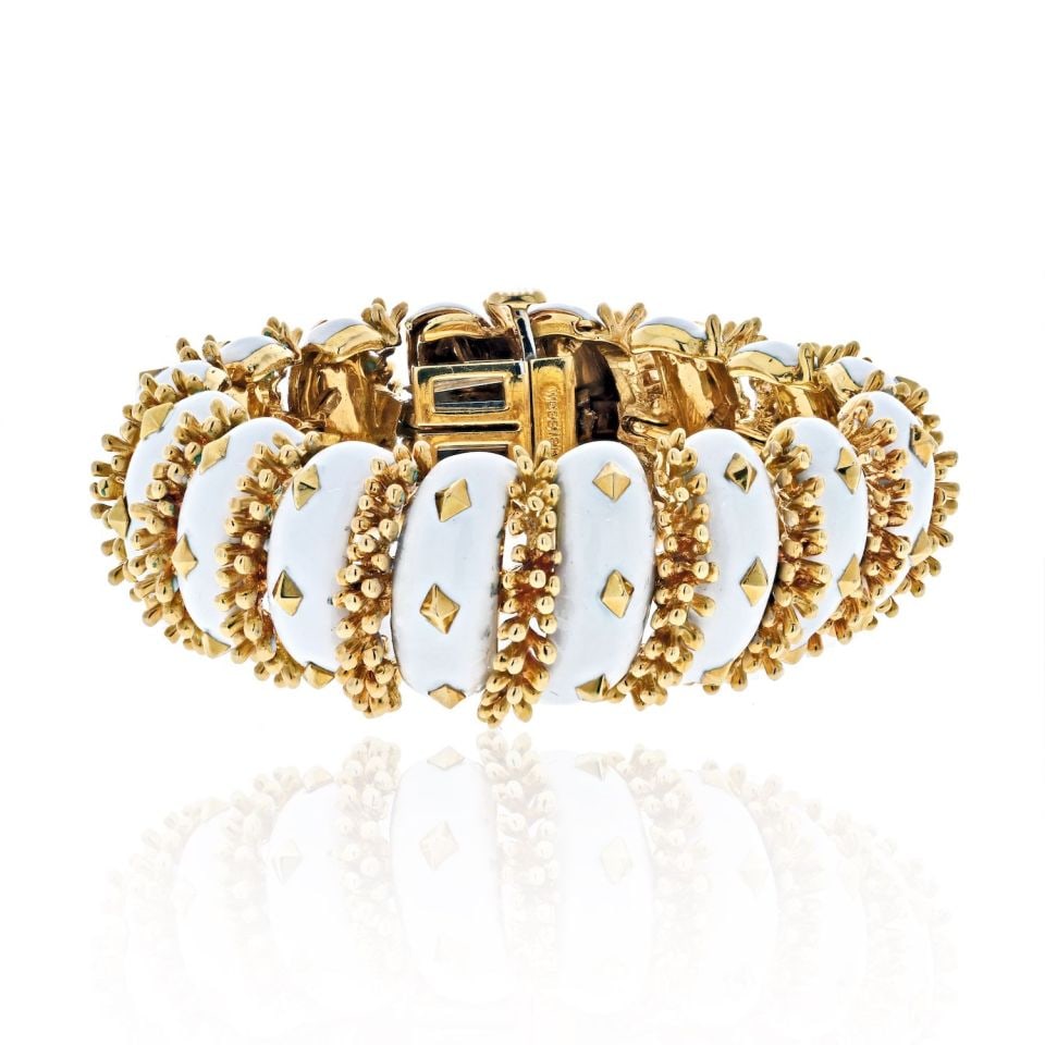 David Webb Articulated Bracelet Platinum 18K Yellow Gold White Enamel: David Webb Articulated Bracelet Platinum 18K Yellow Gold White Enamel Discover the elegance of this David Webb articulated bracelet crafted from a stunning combination of platinum and 18K yellow gold.