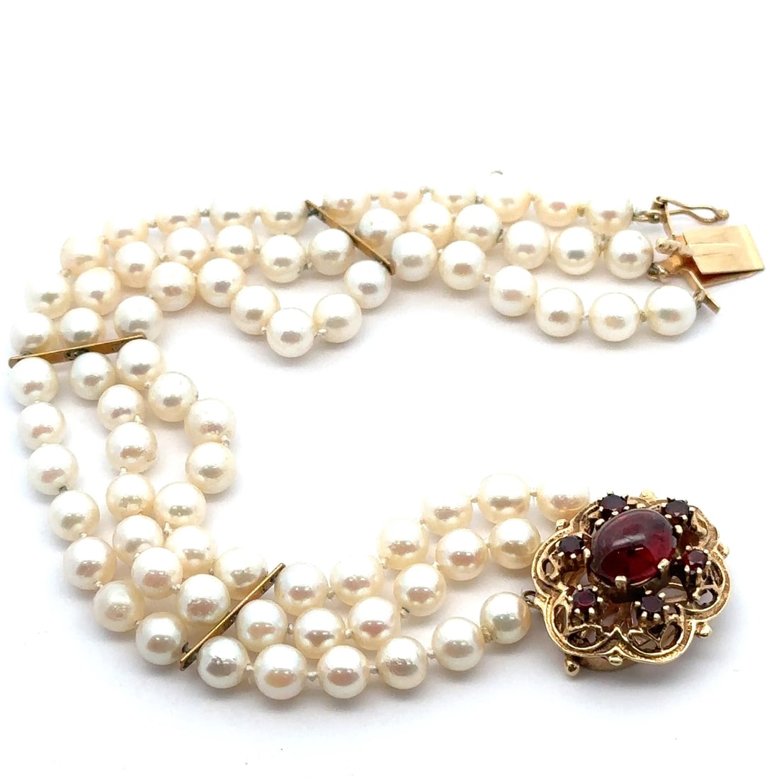 Vintage 3 Strand Natural Pearl Bracelet with 14K Yellow Gold Garnet Clasp: Vintage 3 Strand Natural Pearl Bracelet with 14K Yellow Gold Garnet Clasp This exquisite vintage 3-strand pearl bracelet combines elegance and sophistication, featuring natural white pearls beautifull