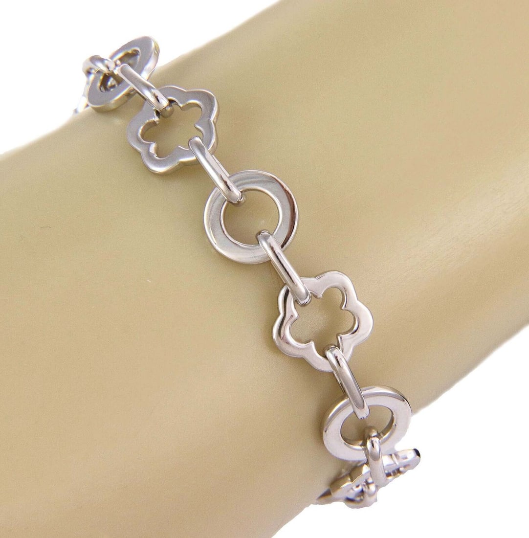 18k White Gold Camellia Floral Charm Bracelet by Chanel 6.75 Inch: 18k White Gold Camellia Floral Charm Bracelet by Chanel 6.75 Inch This authentic Chanel Camellia charm link bracelet is crafted from solid 18k white gold and features a series of intricately detailed