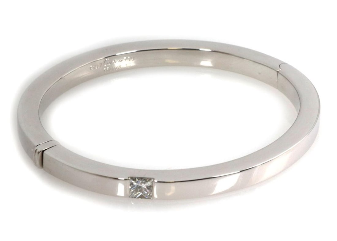 Cartier Tank 18k White Gold Bangle with Princess Cut Diamond Size 16: Cartier Tank 18k White Gold Bangle with Princess Cut Diamond Size 16 This authentic Cartier Tank bangle bracelet is crafted from solid 18k white gold and features a princess-cut diamond accent. The de