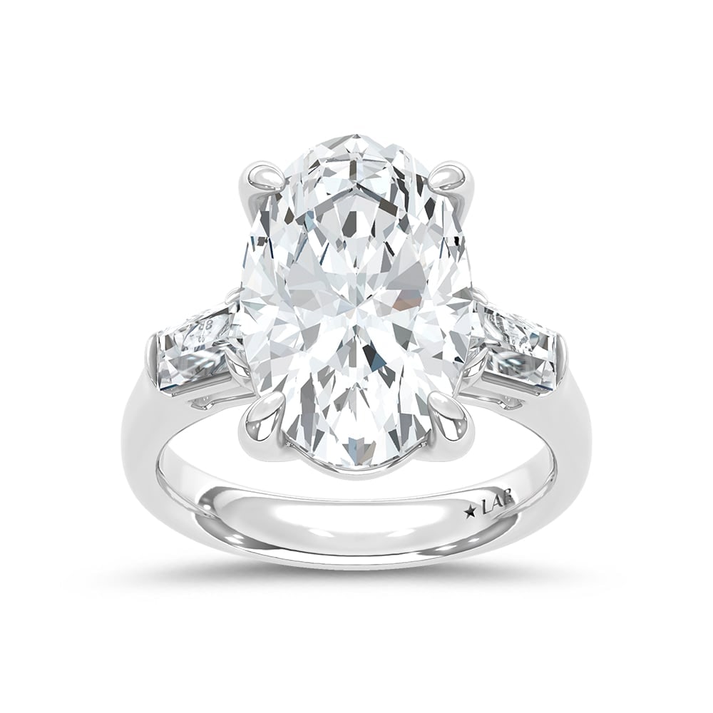 14K White Gold Lab Grown Diamond 7 1/2 Ct.Tw. Oval and Tapper Three Stone Engagement Ring: 14K White Gold Lab Grown Diamond 7 1/2 Ct.Tw. Oval and Tapper Three Stone Engagement Ring This stunning three-stone ring features a sparkling 7 CT Oval Center diamond with two shimmering side diamonds