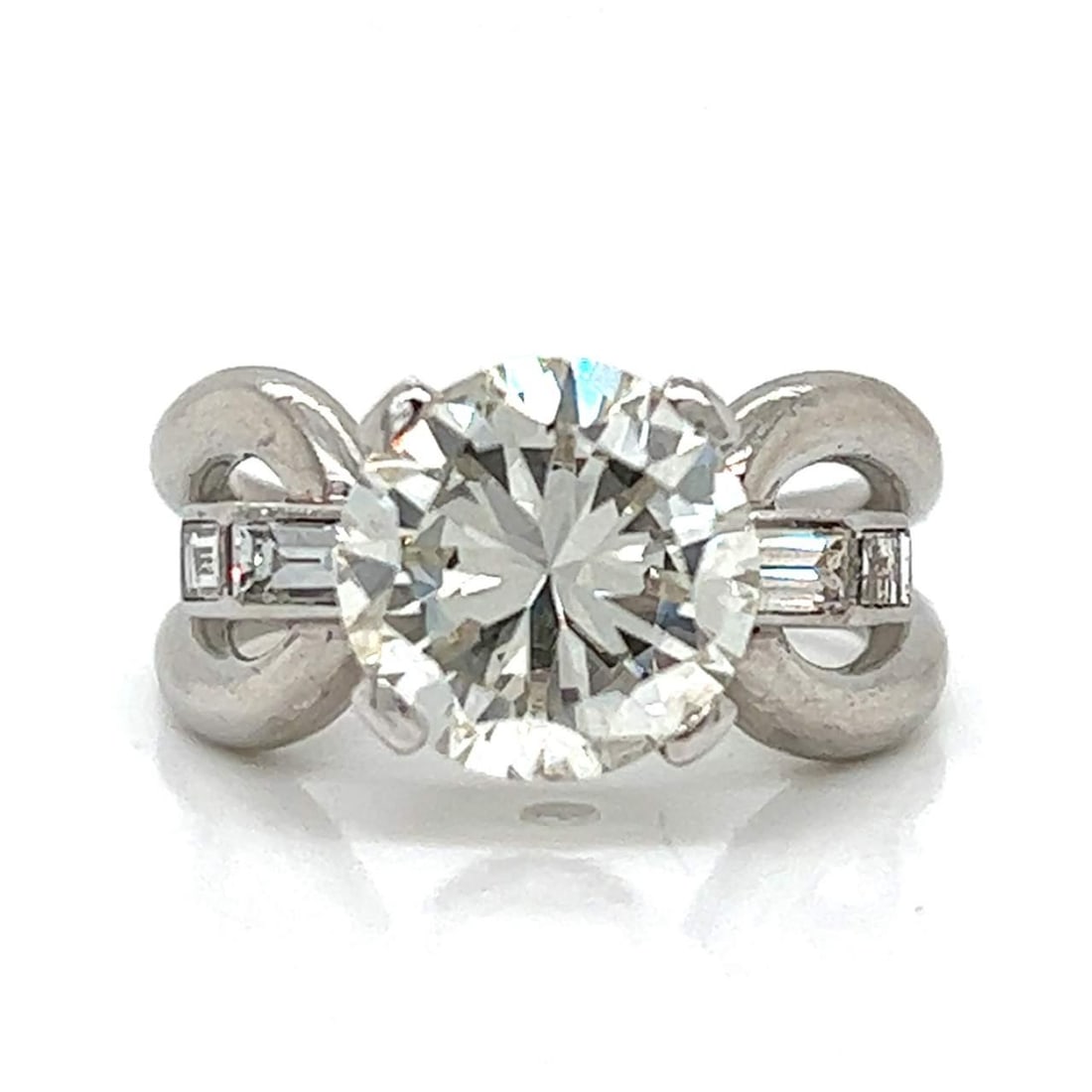 Art Deco Platinum GIA Certified 4.04 Ct Diamond Ring with Baguettes: Art Deco Platinum GIA Certified 4.04 Ct Diamond Ring with Baguettes This exquisite Art Deco ring showcases a stunning GIA Certified 4.04 Ct. round diamond, set in luxurious platinum. The center diamon