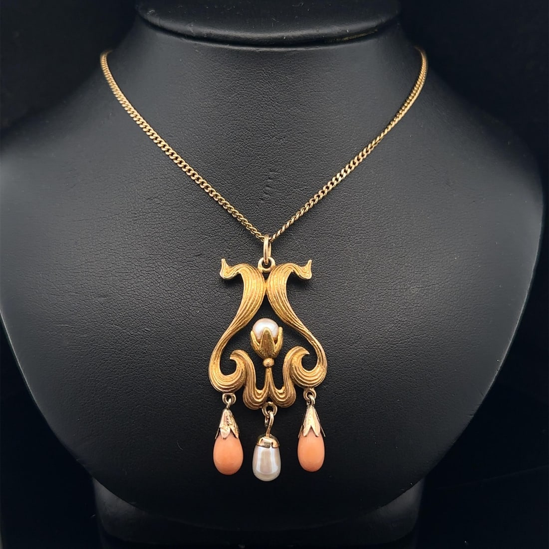 Art Nouveau Era Yellow Gold Lavalier Necklace With Coral and Pearl Drops: Art Nouveau Era Yellow Gold Lavalier Necklace With Coral and Pearl Drops This antique Art Nouveau lavalier pendant necklace features a detailed drop design with genuine cultured pearls and natural cor