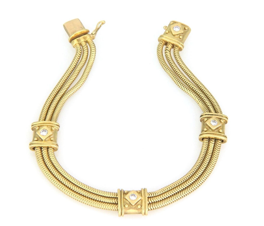 18k Yellow Gold Snake Motif Chain Bracelet with Diamonds by SeidenGang: 18k Yellow Gold Snake Motif Chain Bracelet with Diamonds by SeidenGang This SeidenGang diamond snake bracelet is crafted from 18k yellow gold and features a distinctive chain style with a snake motif 