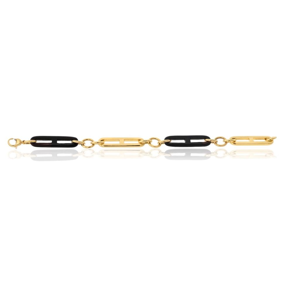 Vintage Gucci 18K Yellow Gold and Wood 9 Inch Link Bracelet: Vintage Gucci 18K Yellow Gold and Wood 9 Inch Link Bracelet This vintage Gucci link bracelet features 18K yellow gold combined with wood accents, offering a refined blend of luxury and natural eleganc