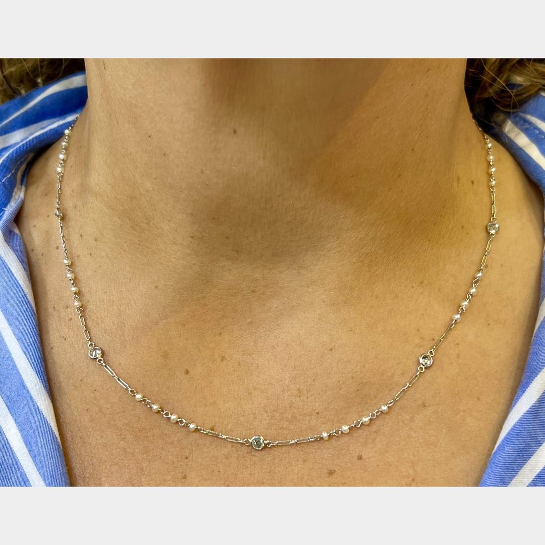 Platinum 18 Inch Natural Pearl & 9 Diamond Necklace: Platinum 18 Inch Natural Pearl & 9 Diamond Necklace This exquisite Platinum Natural Pearl & Diamond by the Yard Necklace features a stunning collection of natural pearls and European-cut diamonds. The