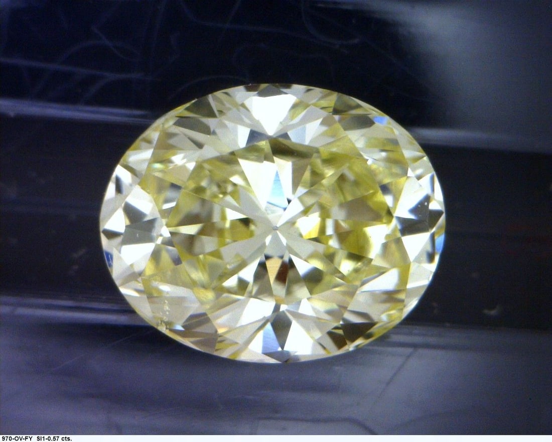 Loose Diamond - OVAL 0.57ct Fancy Yellow: Loose Diamond - OVAL 0.57ct Fancy Yellow Source: Natural Shape: OVAL Carats: 0.57 Color: Fancy Yellow Certification: GIA The Diamond Depot Guarantee: All items in this auction are guaranteed to be 100