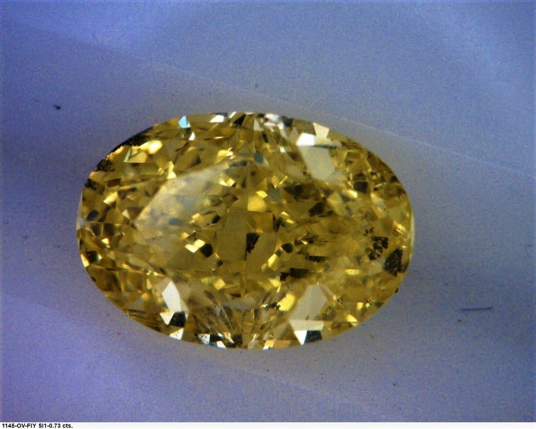 Loose Diamond - OVAL 0.73ct Fancy Intense Yellow SI1: Loose Diamond - OVAL 0.73ct Fancy Intense Yellow SI1 Source: Natural Shape: OVAL Carats: 0.73 Color: Fancy Intense Yellow Certification: GIA The Diamond Depot Guarantee: All items in this auction are 