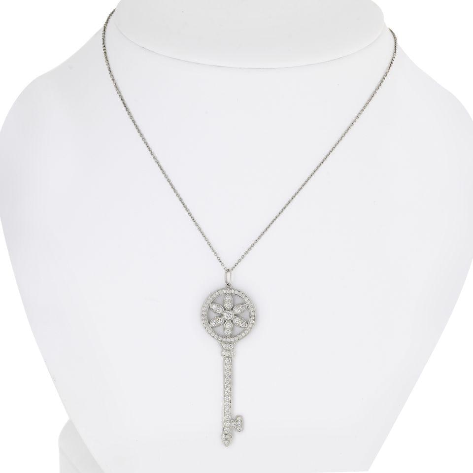 Tiffany & Co. Daisy Platinum Diamond Key Pendant 2.25 inches with Chain: Tiffany & Co. Daisy Platinum Diamond Key Pendant 2.25 inches with Chain This exquisite Tiffany & Co. Daisy Platinum Diamond Key Pendant is a stunning symbol of optimism and hope. Crafted from luxuriou