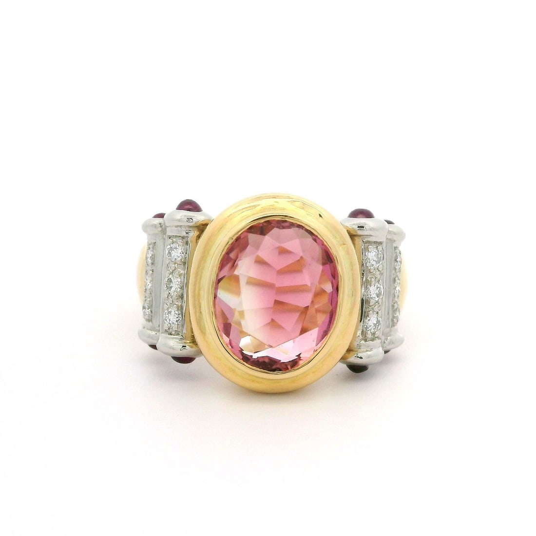 18k Yellow Gold Pink Tourmaline Ruby Diamond Cocktail Ring: 18k Yellow Gold Pink Tourmaline Ruby Diamond Cocktail Ring This stunning cocktail ring showcases a striking natural pink tourmaline at its center, brilliantly cut and set in an oval bezel. The tourmal