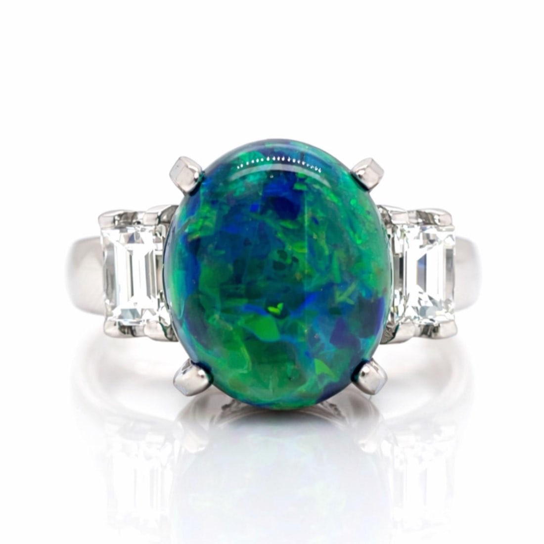 Opal and Diamond Platinum Ring 3.53 Carat Center Gemstone: Opal and Diamond Platinum Ring 3.53 Carat Center Gemstone This platinum ring features a 3.53 ct opal as the centerpiece, accented by two diamonds totaling 0.58 ct with G-H color and VVS-VS clarity. Th