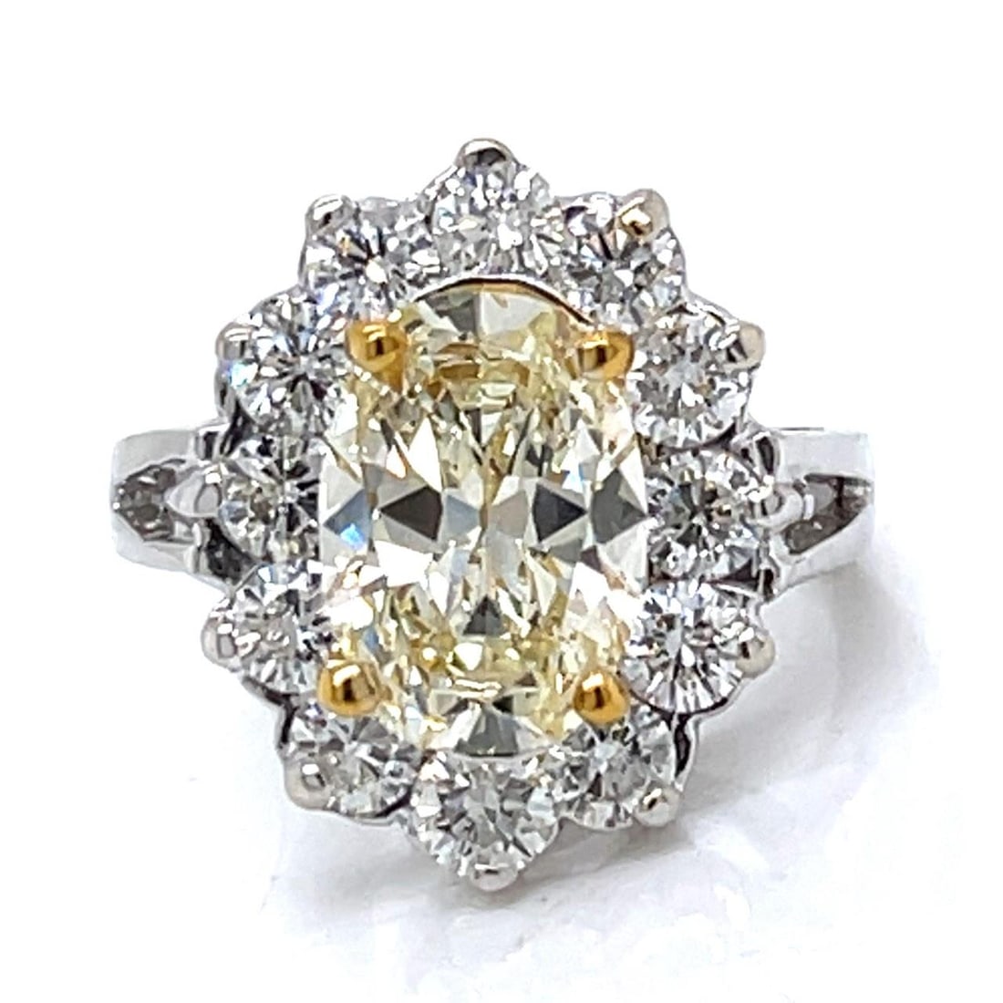 14K White Gold Fancy Yellow Diamond Ring 2.82 Ct Oval: 14K White Gold Fancy Yellow Diamond Ring 2.82 Ct Oval This stunning 14K White Gold ring showcases a breathtaking 2.82 Ct. Fancy Yellow Oval Diamond at its center, exhibiting VVS clarity. Surrounding t