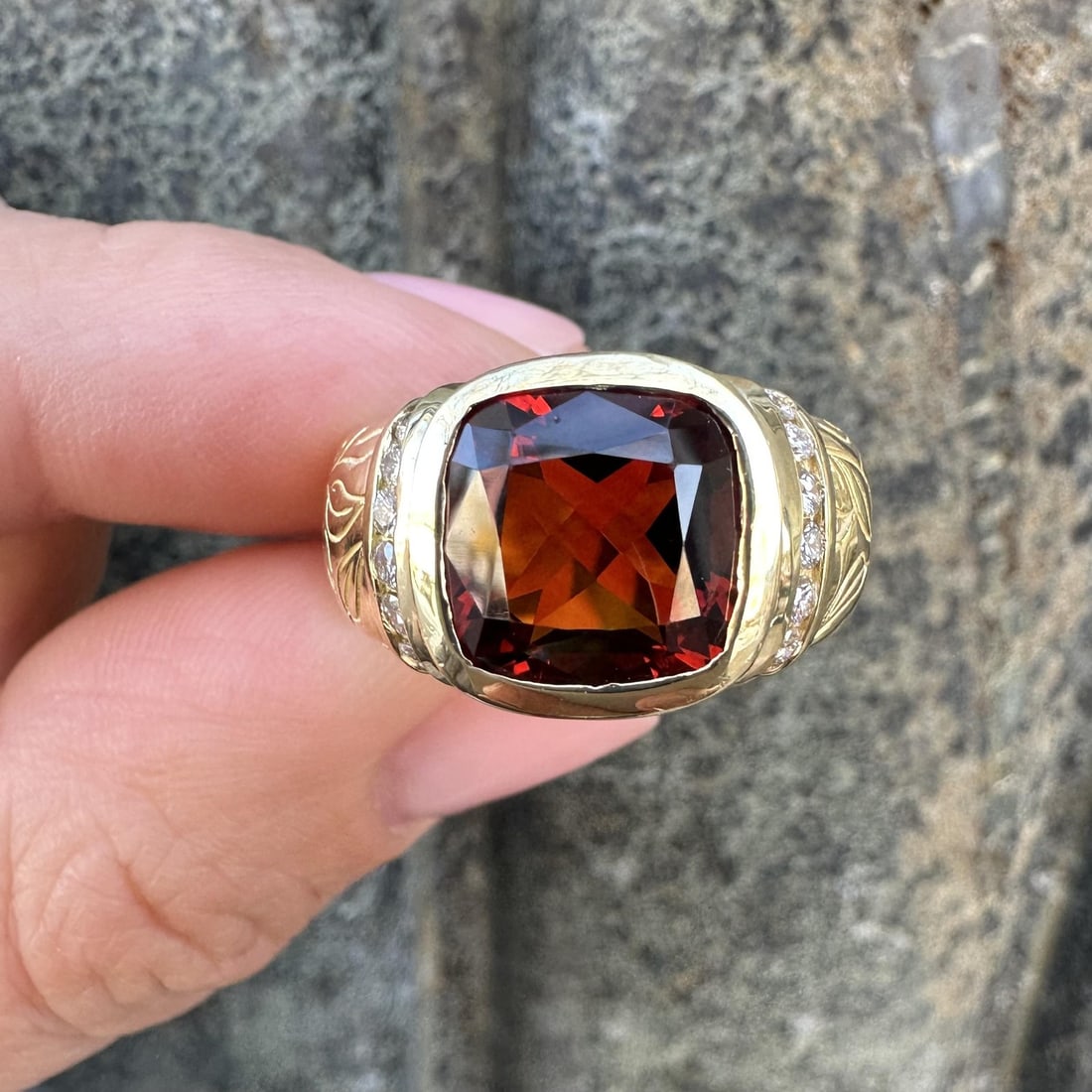 18k Yellow Gold Hand Engraved Bezel Ring with Garnet and Diamond Accents: 18k Yellow Gold Hand Engraved Bezel Ring with Garnet and Diamond Accents This Seidengang cocktail ring features a cushion-cut natural Madeira citrine set in a hand-engraved bezel of solid 18k yellow g