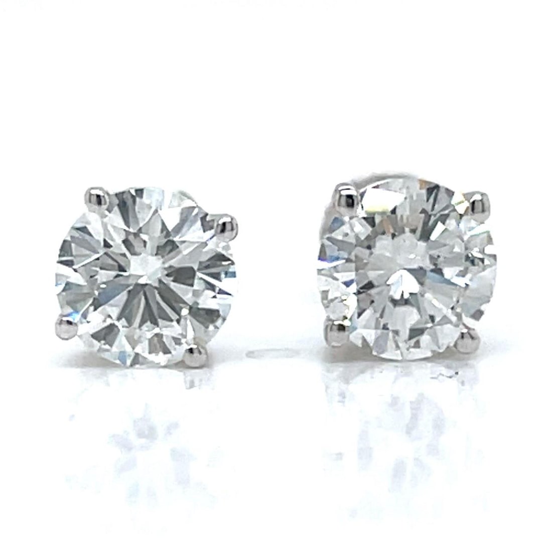 Diamond Stud Earrings in 14K White Gold with GIA Certification 2.03 Carat Total: Diamond Stud Earrings in 14K White Gold with GIA Certification 2.03 Carat Total These stud earrings feature two GIA certified round diamonds, one weighing 1.02 ct with H color and SI1 clarity, and the