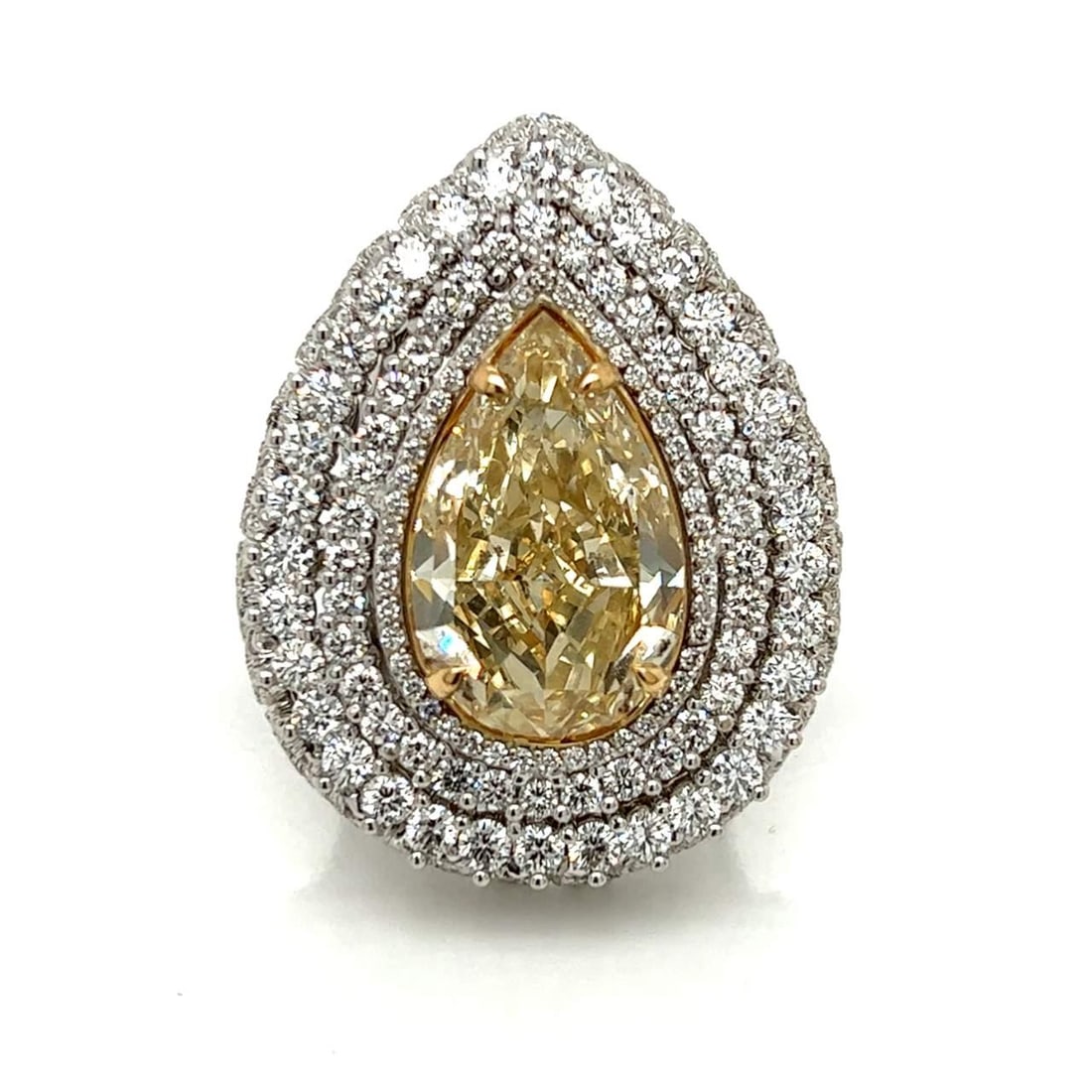 18K White Gold 12.10 Ct GIA Certified Pear Diamond Ring: 18K White Gold 12.10 Ct GIA Certified Pear Diamond Ring This exquisite 18K White Gold ring features a stunning 12.10 Ct. GIA Certified pear-shaped diamond, showcasing a natural fancy brownish yellow c