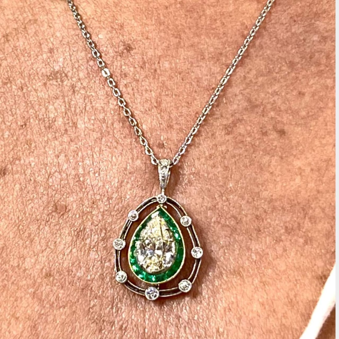 2.25 Ct Pear Shape Diamond Pendant with Emeralds in 14K White Gold and Platinum: 2.25 Ct Pear Shape Diamond Pendant with Emeralds in 14K White Gold and Platinum This exquisite 2.25 Ct Pear Shape Diamond Pendant features a stunning center diamond weighing 2.25 Ct, boasting an M col