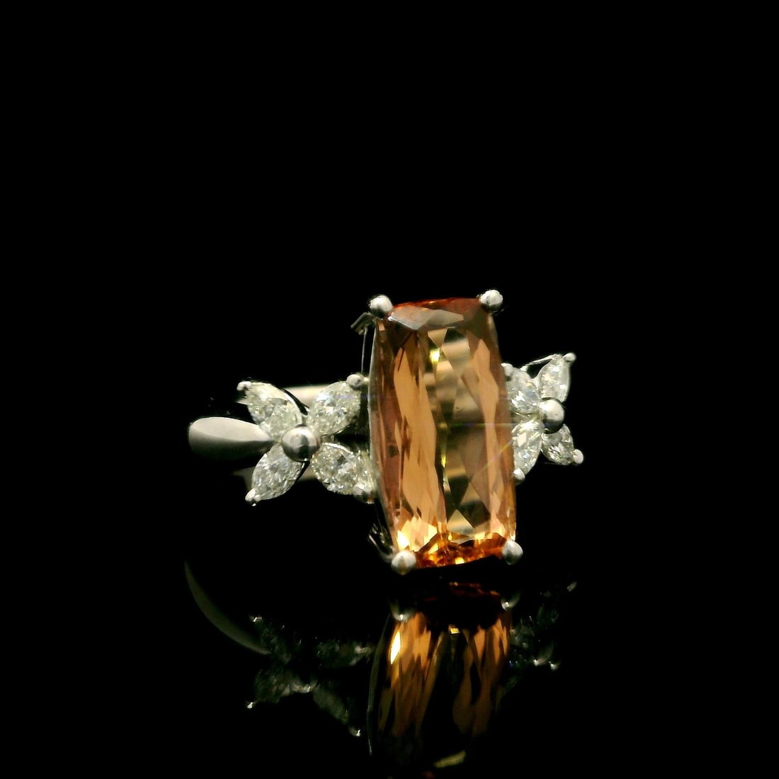 Platinum 3.26ctw Orange Topaz Diamond Cocktail Ring: Platinum 3.26ctw Orange Topaz Diamond Cocktail Ring This exquisite cocktail ring features a stunning long cushion-cut natural orange topaz, beautifully prong set and measuring 11.7 x 6 mm, totaling 2.