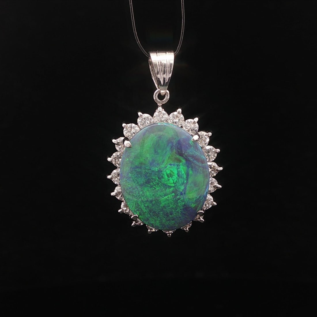 Platinum Pendant With 5.92ct Opal and Diamond Halo Vintage Jewelry: Platinum Pendant With 5.92ct Opal and Diamond Halo Vintage Jewelry This vintage pendant features a vibrant natural opal with gray base and lively green and blue play of colors, expertly cut in an oval