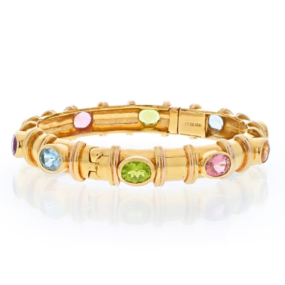 David Webb 18K Gold Multi-Colored Gemstone Bangle Bracelet: David Webb 18K Gold Multi-Colored Gemstone Bangle Bracelet This exquisite bangle bracelet by David Webb is crafted from 18K yellow gold and features a stunning array of nine oval cut multi-colored gem