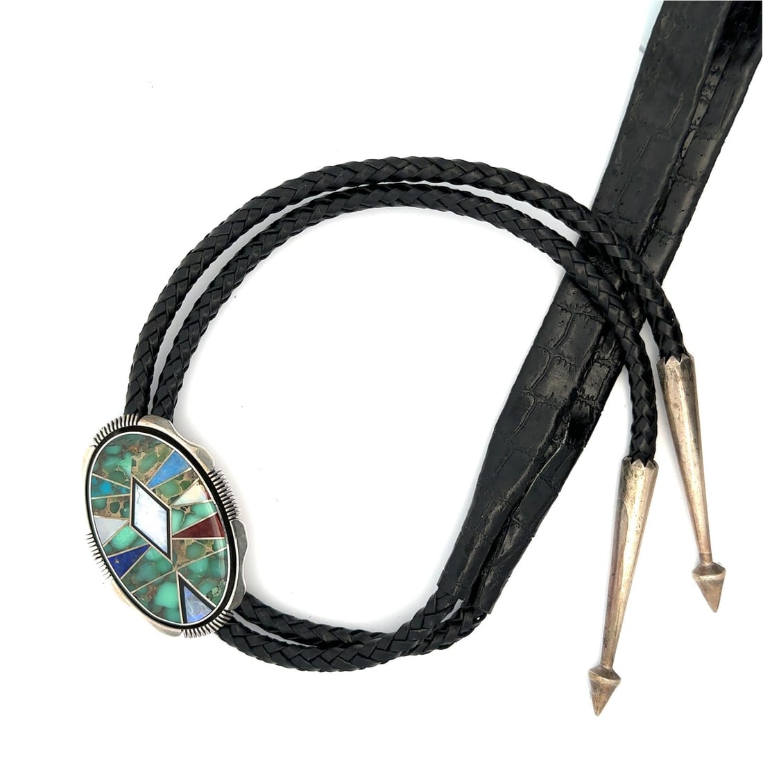 Sterling Silver Bolo Tie with Mother of Pearl Turquoise Lapis Inlay by Gilbert Nelson: Sterling Silver Bolo Tie with Mother of Pearl Turquoise Lapis Inlay by Gilbert Nelson This vintage bolo tie by Gilbert Nelson features a striking inlay of custom-cut Mother of Pearl, Turquoise, Lapis 