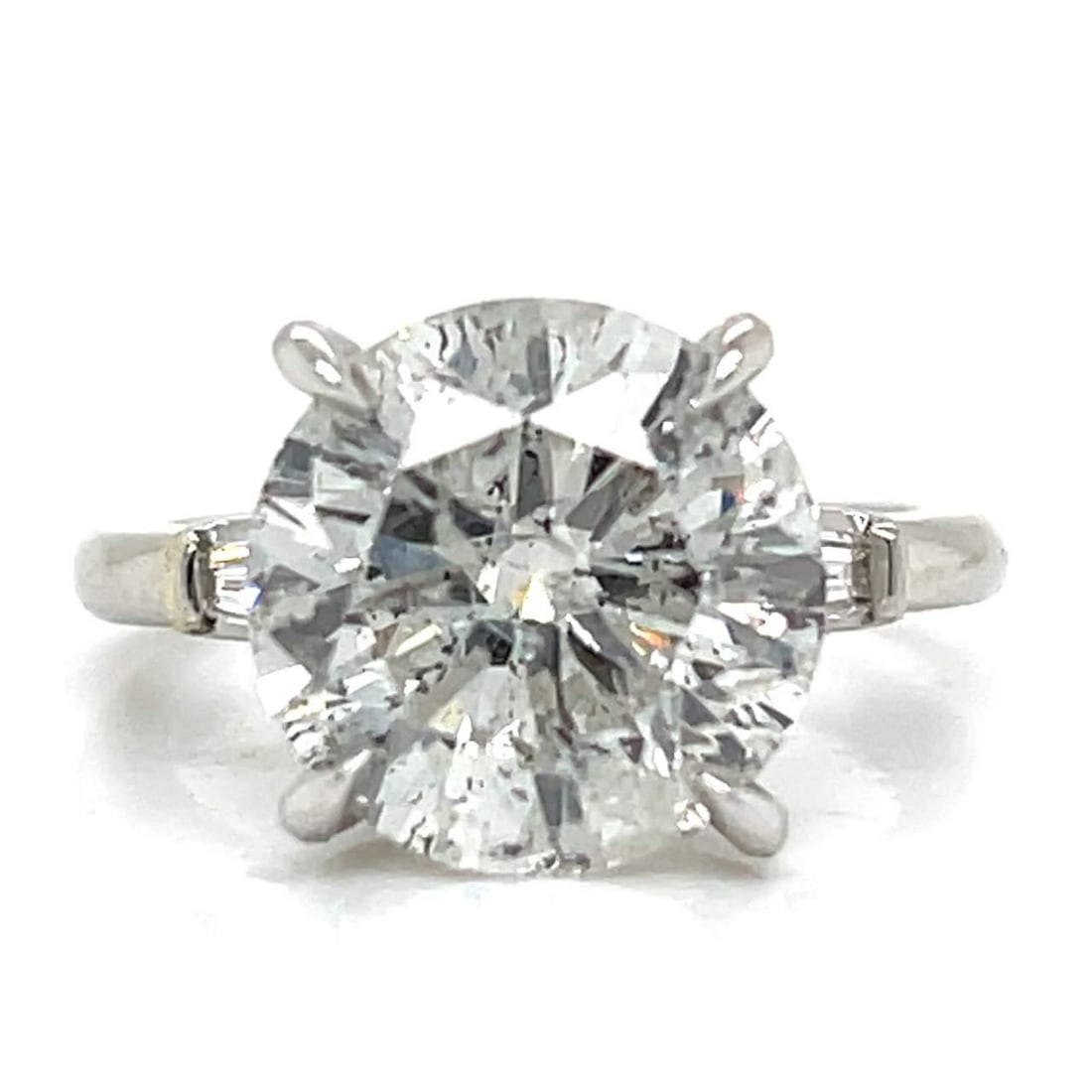 EGL Certified 6.02 Ct Platinum Diamond Ring with 2 Additional Diamonds: EGL Certified 6.02 Ct Platinum Diamond Ring with 2 Additional Diamonds This exquisite platinum ring features a stunning EGL Certified round diamond weighing 6.02 carats, measuring 12.06 - 12.00 x 6.89