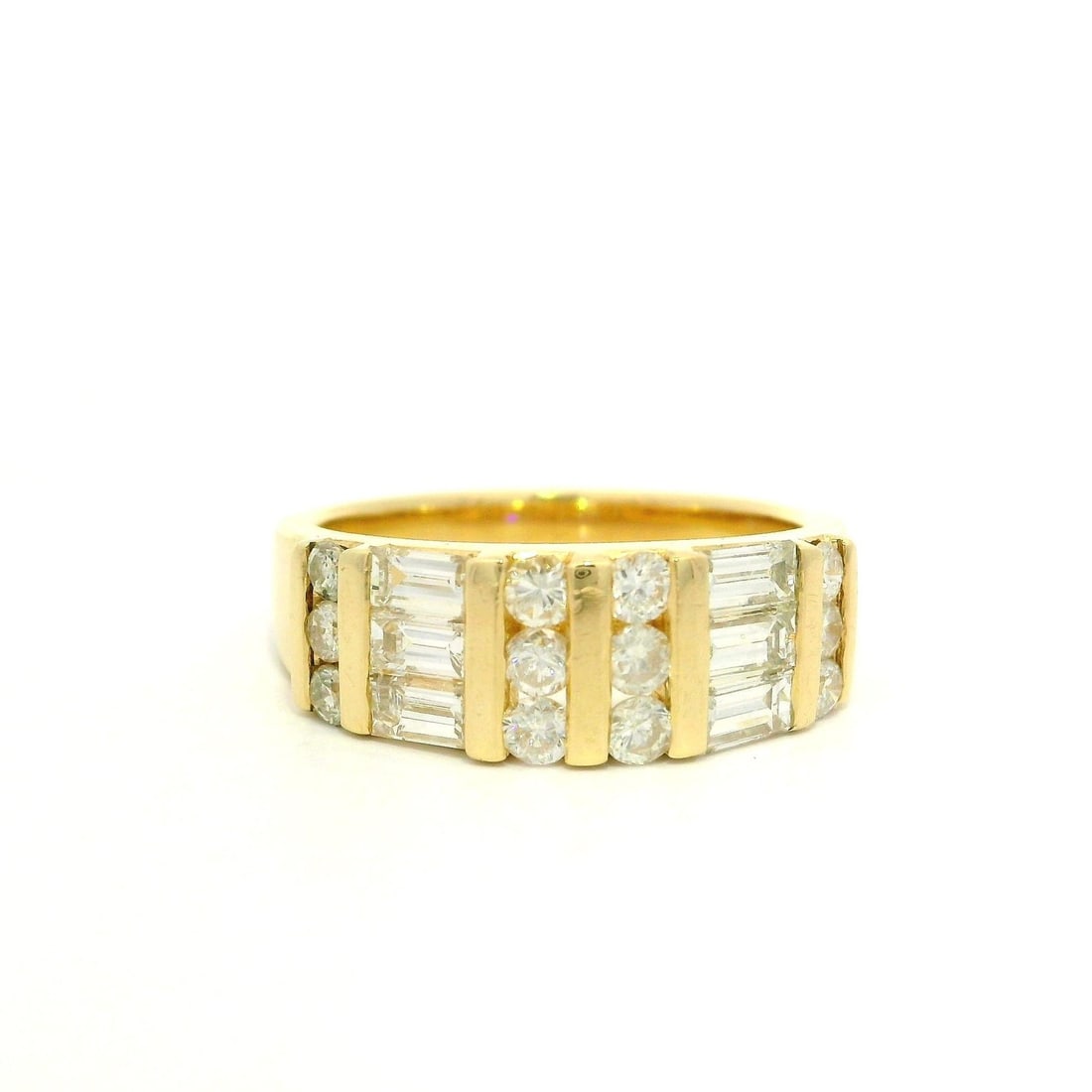 14k Yellow Gold 1.21ctw Diamond Channel Set Band Ring: 14k Yellow Gold 1.21ctw Diamond Channel Set Band Ring This stunning cocktail ring features a unique design crafted in solid 14k yellow gold, showcasing a total of 1.21 carats of brilliant diamonds. Th