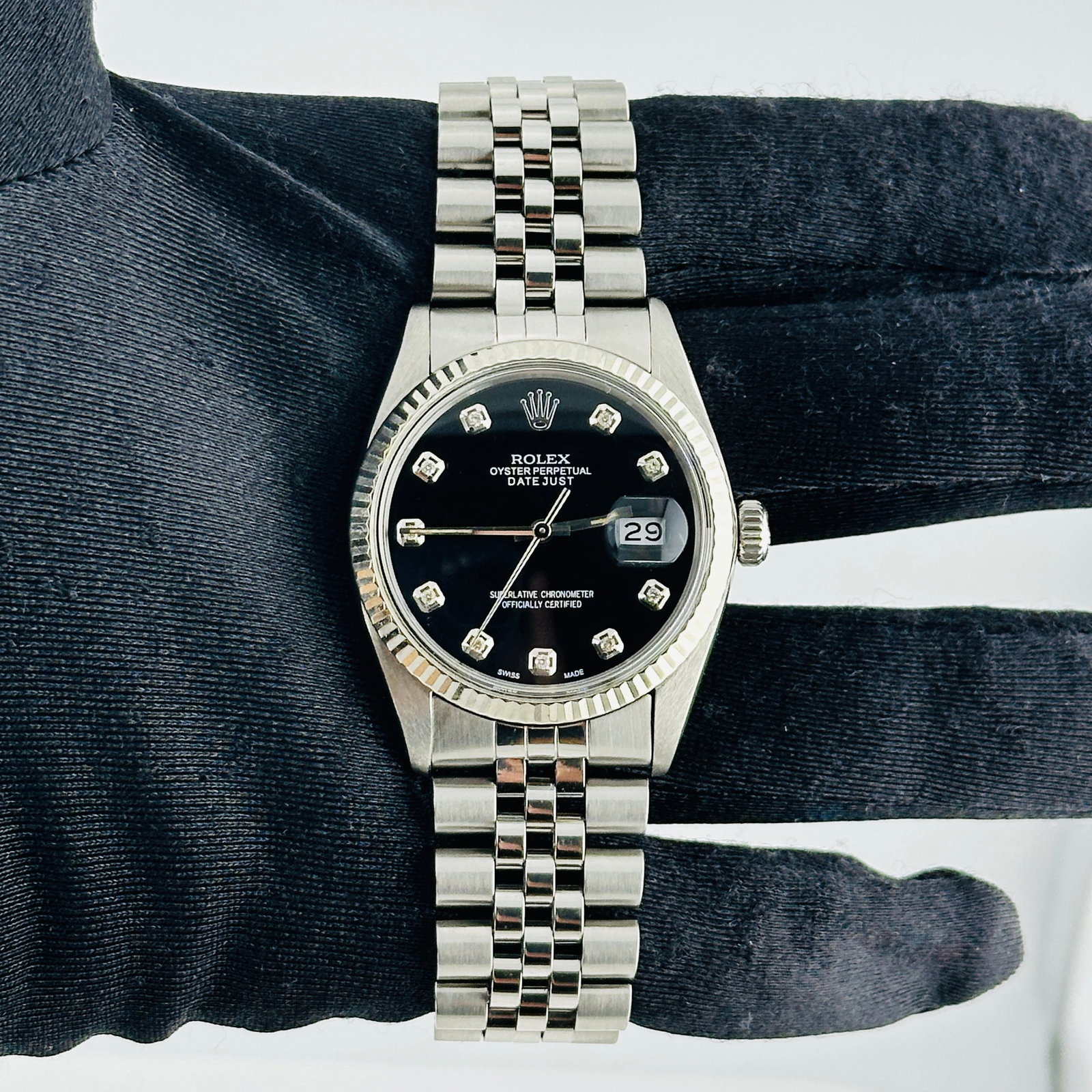 Datejust Ref 16014 Mens Watch With Aftermarket Black Diamond Dial: Datejust Ref 16014 Mens Watch With Aftermarket Black Diamond Dial This Rolex Datejust features a silver dial and a fluted bezel, complemented by a D-Link Jubilee bracelet. It is a men's watch with the