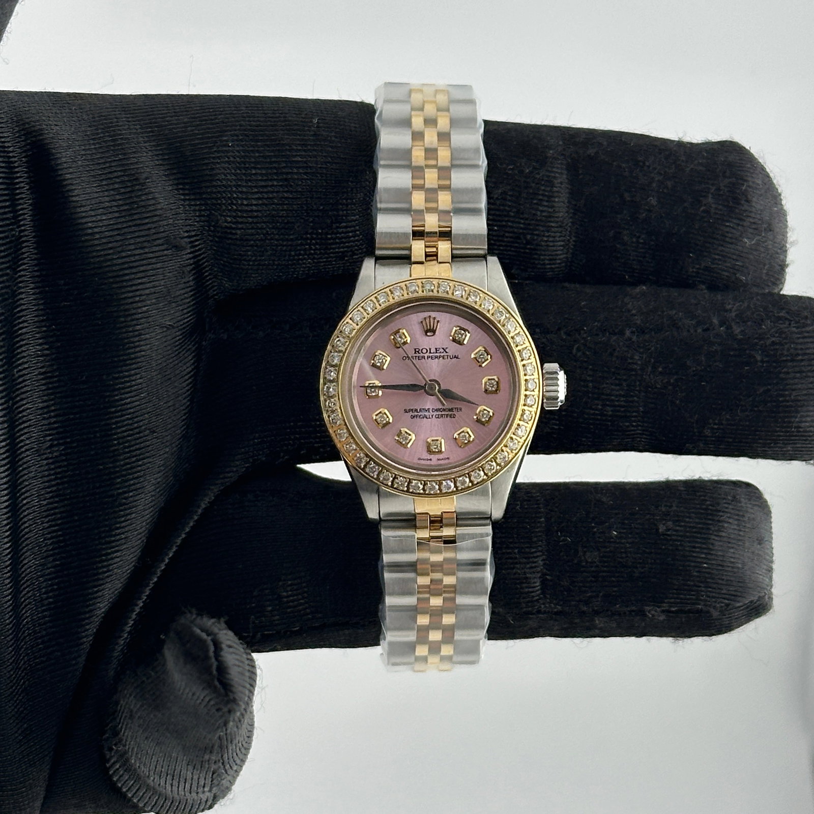 Ladies Aftermarket Pink Diamond Dial Jubilee Bracelet Rolex 6406 Oyster Perpetual: Ladies Aftermarket Pink Diamond Dial Jubilee Bracelet Rolex 6406 Oyster Perpetual This Rolex Oyster Perpetual ladies watch features an aftermarket pink diamond dial, a pave plated diamond bezel, and a
