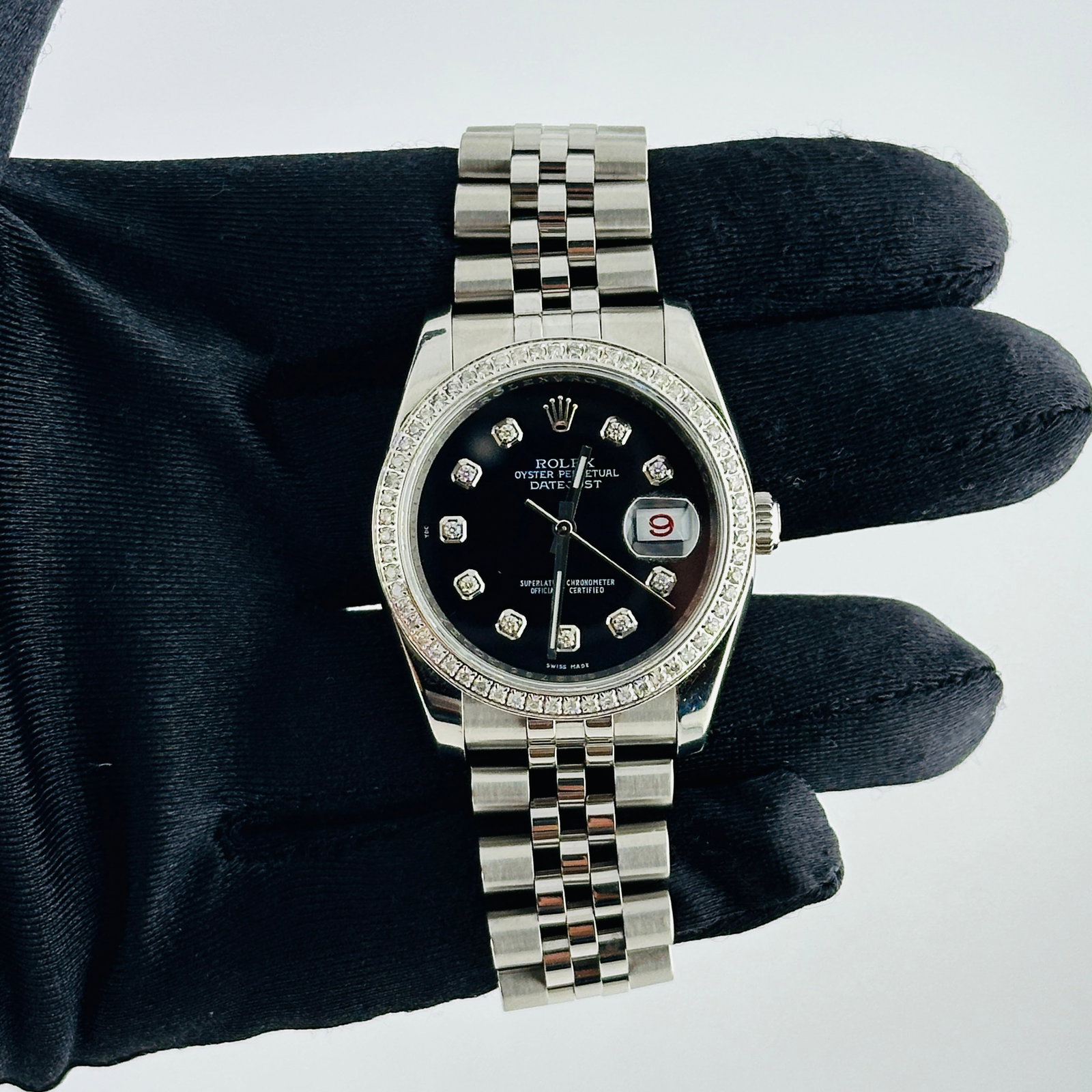 Aftermarket Diamond Black Dial Datejust Watch Ref 116200 Jubilee Bracelet: Aftermarket Diamond Black Dial Datejust Watch Ref 116200 Jubilee Bracelet This Rolex Datejust features an aftermarket black dial adorned with diamond hour markers and a diamond pave bezel. It is prese