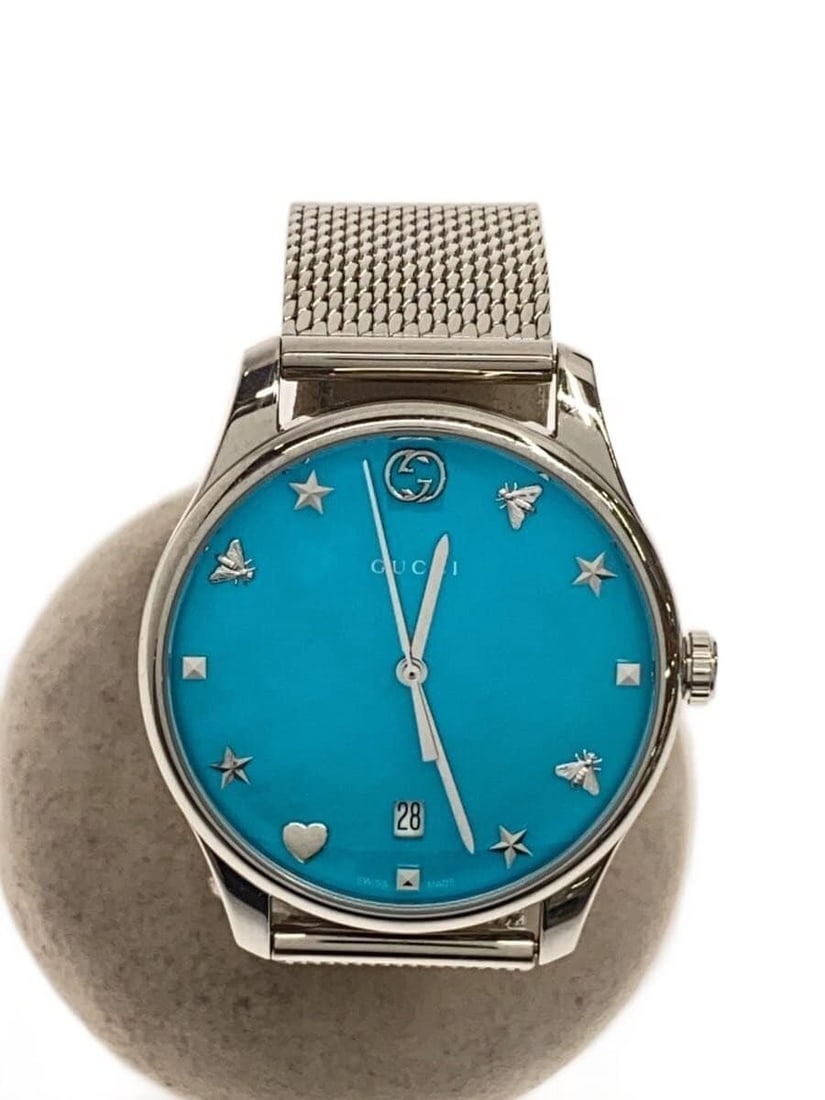 Gucci G Timeless Quartz Blue Dial Men's Wristwatch: Gucci G Timeless Quartz Blue Dial Men's Wristwatch This is a pre-owned GUCCI G-TIMELESS Quartz 126.4 men's wristwatch with a blue dial. The watch is Swiss-made and features a quartz movement. It shows