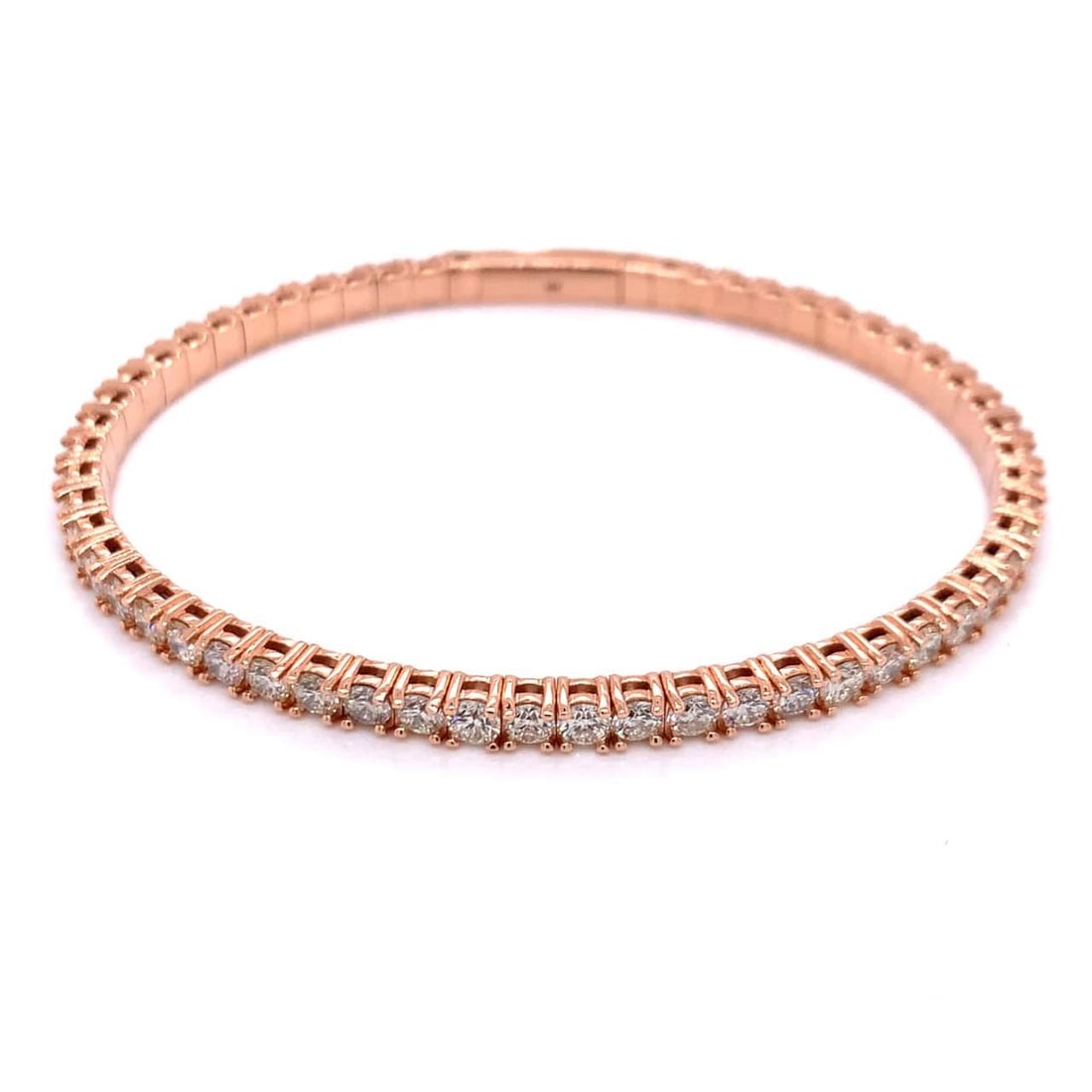 14K Rose Gold 5.25 Ct Diamond Bangle with 59 Diamonds: 14K Rose Gold 5.25 Ct Diamond Bangle with 59 Diamonds This exquisite bangle features a stunning arrangement of 59 round diamonds, totaling approximately 5.25 carats, set in luxurious 14K rose gold. Th
