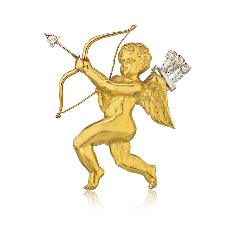 Mellerio Dits Platinum 18K Gold Diamond Cupid Brooch 44mm x 31mm: Mellerio Dits Platinum 18K Gold Diamond Cupid Brooch 44mm x 31mm This exquisite brooch features a charming Cupid design crafted from a stunning combination of platinum and 18K yellow gold. Weighing 12