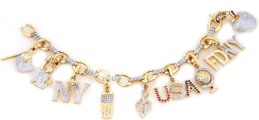 14k Gold NY Charms Bracelet with 3ct Diamonds Rubies and Sapphires: 14k Gold NY Charms Bracelet with 3ct Diamonds Rubies and Sapphires This stunning charms chain bracelet showcases a unique and iconic design, expertly crafted from 14k yellow and white gold. The
