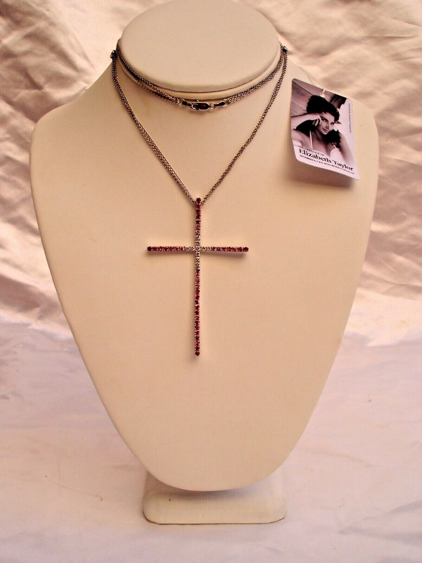 Elizabeth Taylor 18K White Gold Diamond Sapphire Cross Pendant: Elizabeth Taylor 18K White Gold Diamond Sapphire Cross Pendant This exquisite cross pendant, crafted from 18K white gold, features dazzling diamonds and vibrant sapphires, showcasing the elegance