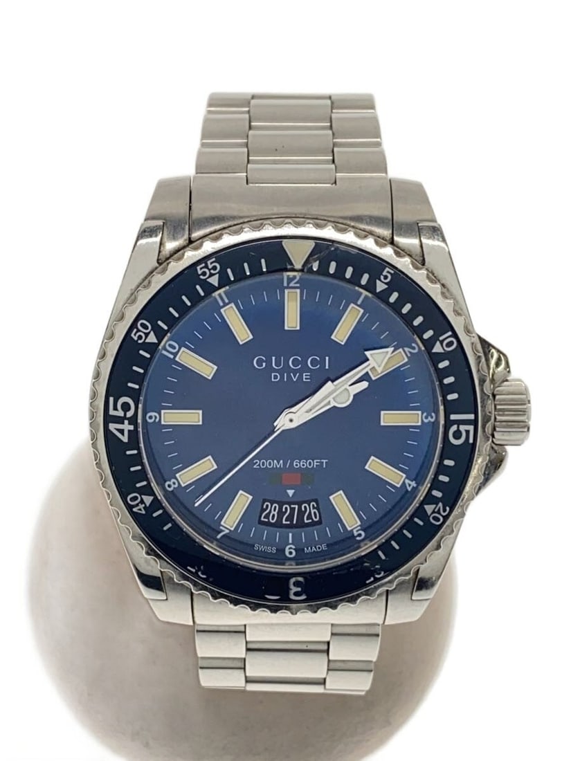 Gucci Dive Navy Stainless Steel Wristwatch YA136311: Gucci Dive Navy Stainless Steel Wristwatch YA136311 This GUCCI DIVE YA136311 men's wristwatch features a navy dial and a stainless steel case and band. Made in Switzerland, the watch shows slight sign
