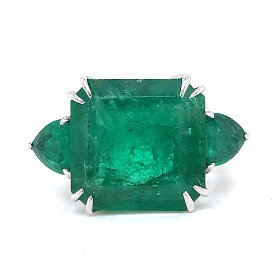 18K White Gold 3-Stone Ring with 13.50 Ct Emeralds: 18K White Gold 3-Stone Ring with 13.50 Ct Emeralds This stunning 18K white gold ring features a captivating 13.50 ct. total weight of emeralds, showcasing an approximate 12.00 ct. emerald at the cente