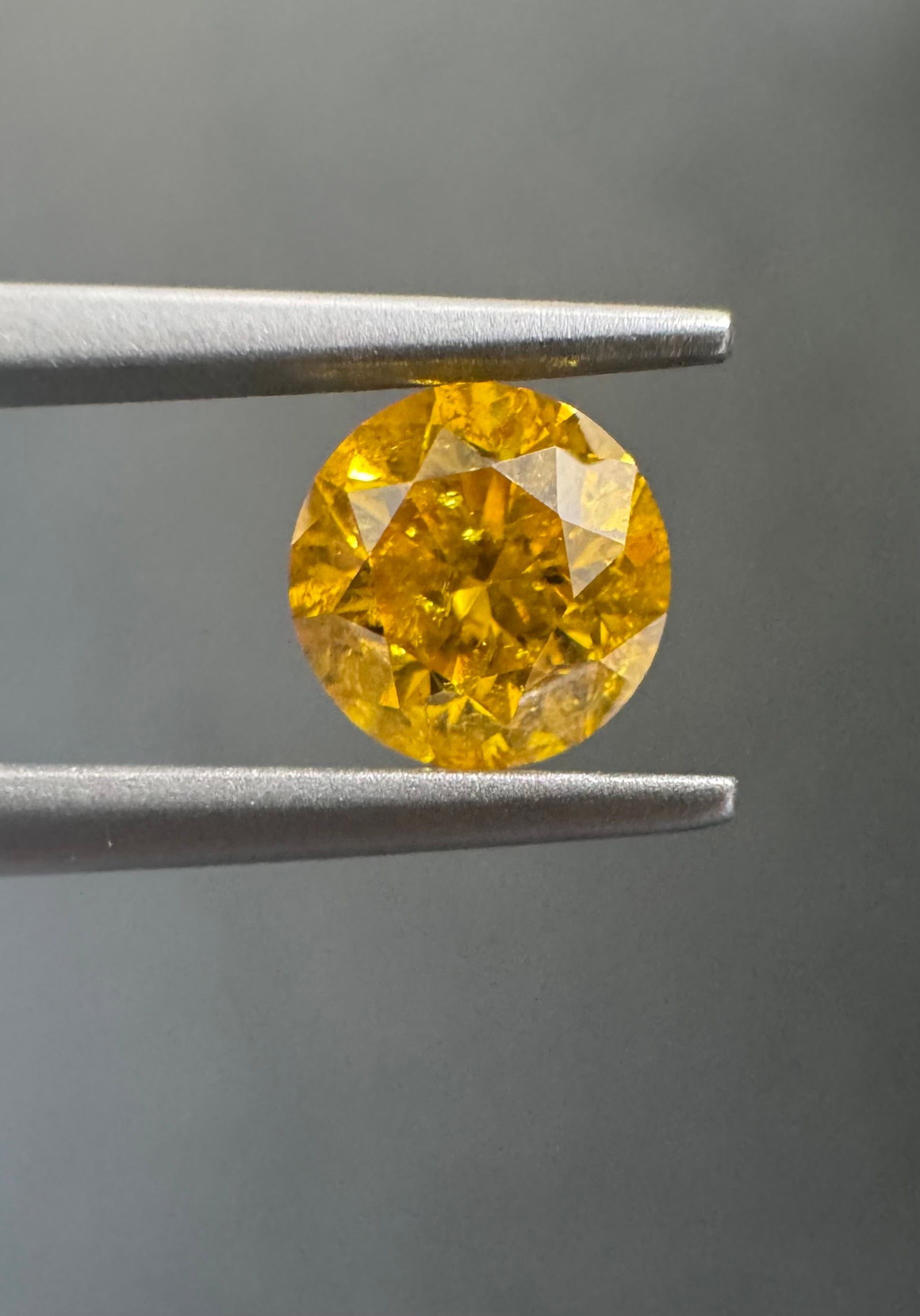 Loose Diamond - ROUND 0.76ct Fancy Vivid Orangey Yellow I3: Loose Diamond - ROUND 0.76ct Fancy Vivid Orangey Yellow I3 Source: Natural Shape: ROUND Carats: 0.76 Color: Fancy Vivid Orangey Yellow Certification: GIA The Diamond Depot Guarantee: All items in this