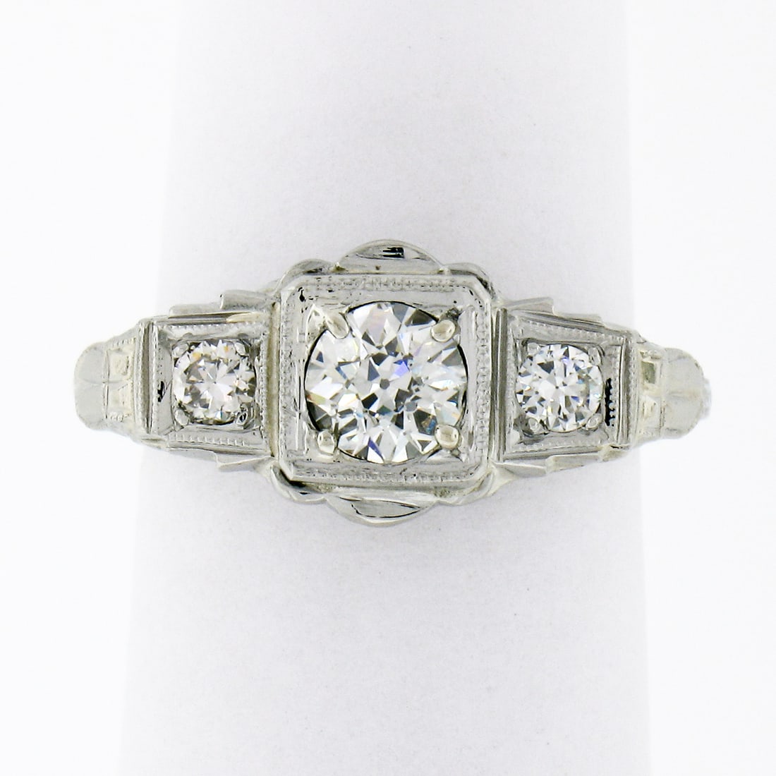 Antique Art Deco 18k White Gold 0.70ctw 3 Stone Diamond Ring: Antique Art Deco 18k White Gold 0.70ctw 3 Stone Diamond Ring This exquisite antique Art Deco ring is crafted from solid 18k white gold and features a stunning three-stone design. The ring showcases