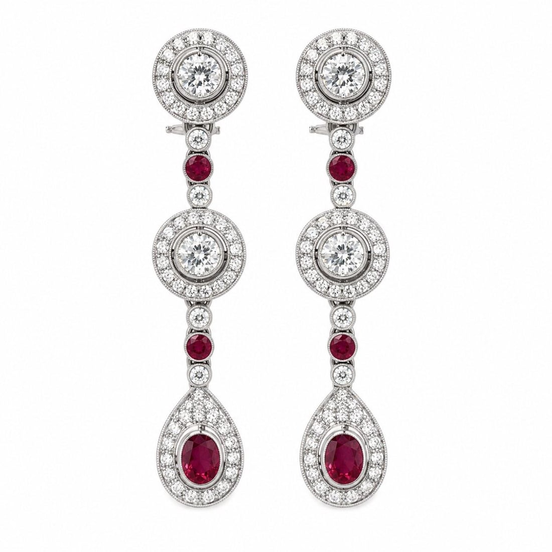 Platinum Art Deco Burma Ruby Diamond Drop Earrings: Platinum Art Deco Burma Ruby Diamond Drop Earrings These Deco-style earrings are crafted from platinum and feature an elegant combination of Burma rubies and diamonds. The earrings are set with two Bu
