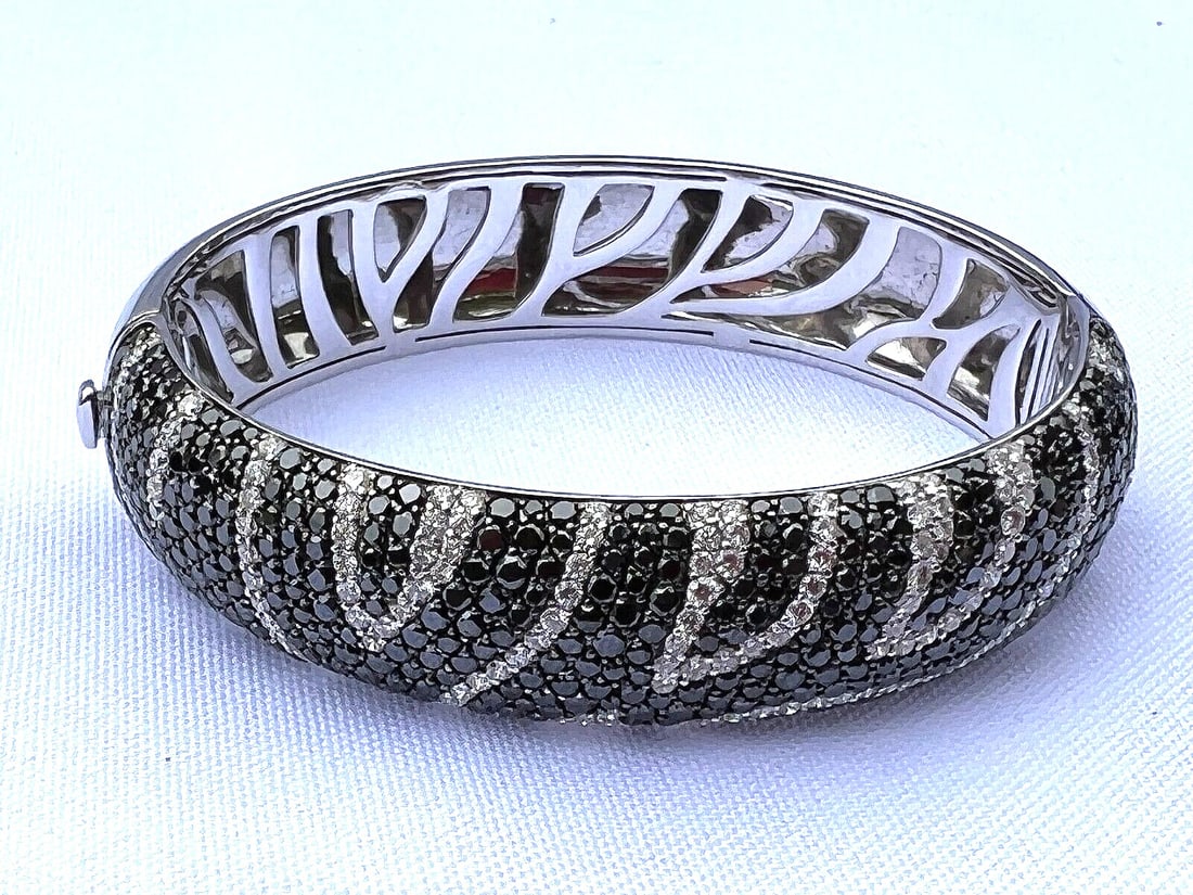 French 18K White Gold Bracelet with Black and White Diamonds: French 18K White Gold Bracelet with Black and White Diamonds Presenting an exquisite French bracelet crafted from 18K white gold, adorned with both black and white diamonds. This classic-style piece b