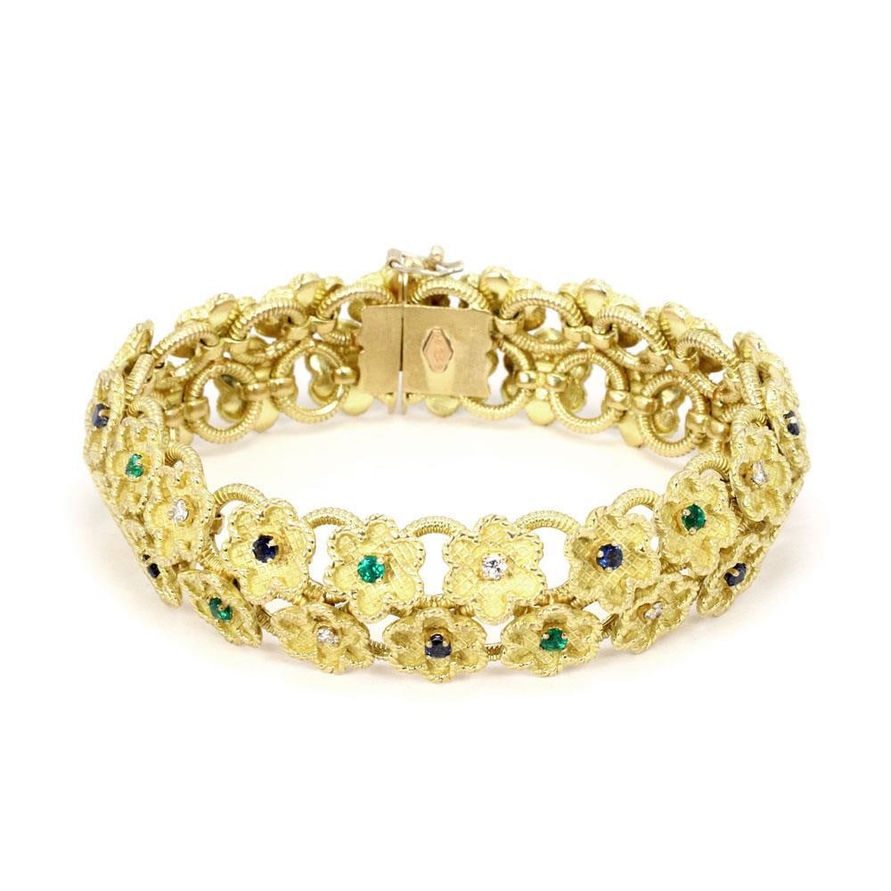 Floral Link Bracelet 18k Yellow Gold Diamonds Sapphires Emeralds: Floral Link Bracelet 18k Yellow Gold Diamonds Sapphires Emeralds This stunning estate bracelet is expertly crafted from 18k yellow gold and features a unique double row of floral links. Each flower sh