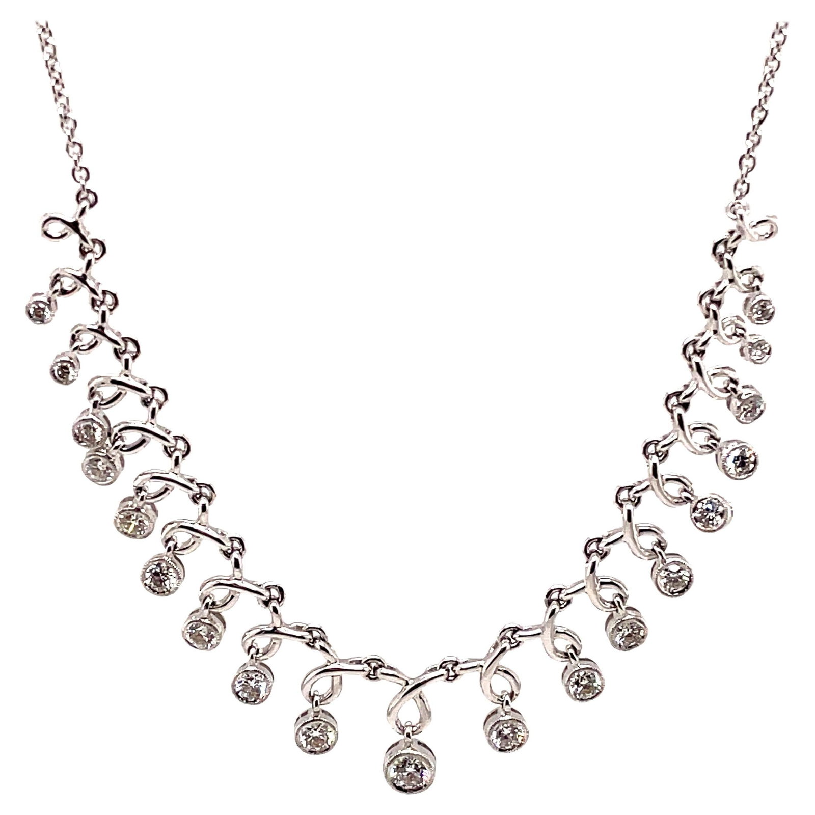 1.24ct Bezel Set Diamond Necklace in 18k White Gold: 1.24ct Bezel Set Diamond Necklace in 18k White Gold This exquisite dangling diamond necklace features 19 round brilliant diamonds, totaling 1.24 carats, elegantly bezel set in 18k white gold. The cont