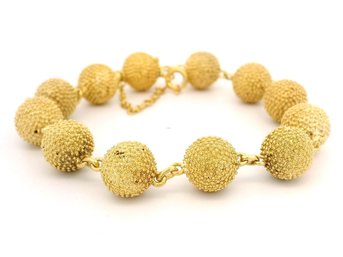 Vintage 18k Yellow Gold Textured Bead Bracelet with Push Clasp: Vintage 18k Yellow Gold Textured Bead Bracelet with Push Clasp This exquisite Vintage European bracelet showcases a stylish design made from solid 18k yellow gold. The textured ball bead design adds a