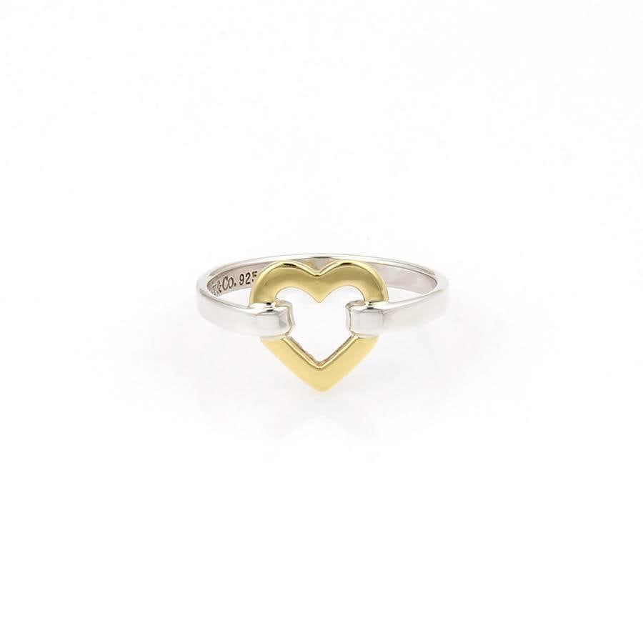 Tiffany & Co. Open Heart Ring 18k Yellow Gold Sterling Silver: Tiffany & Co. Open Heart Ring 18k Yellow Gold Sterling Silver This exquisite open heart ring by Tiffany & Co. features a beautifully crafted design in 18k yellow gold and sterling silver. The ring sho