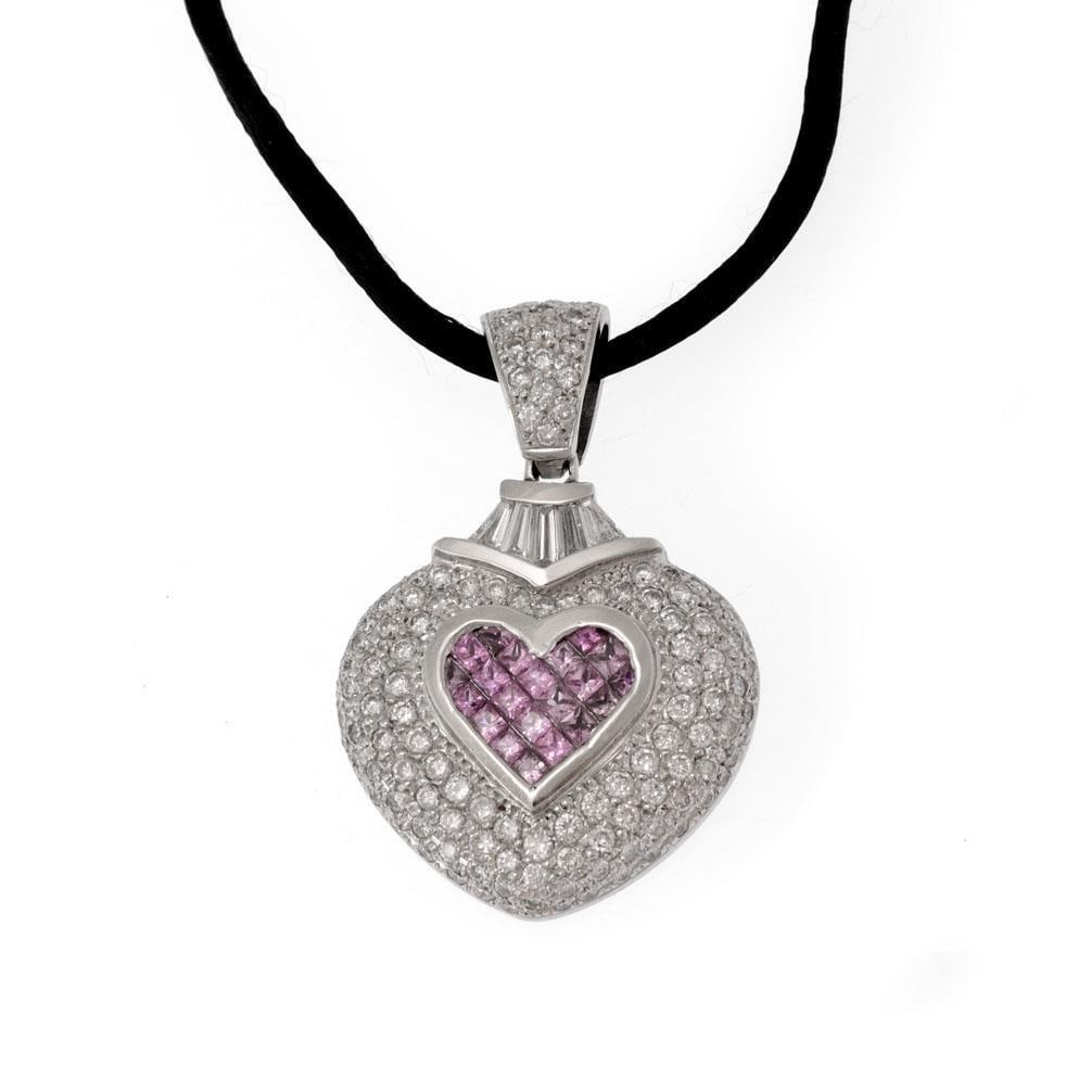 18k White Gold Diamond Pink Sapphire Heart Pendant with Cord: 18k White Gold Diamond Pink Sapphire Heart Pendant with Cord This stunning pendant showcases a large double heart design elegantly crafted from 18k white gold. At the center, a small heart features an
