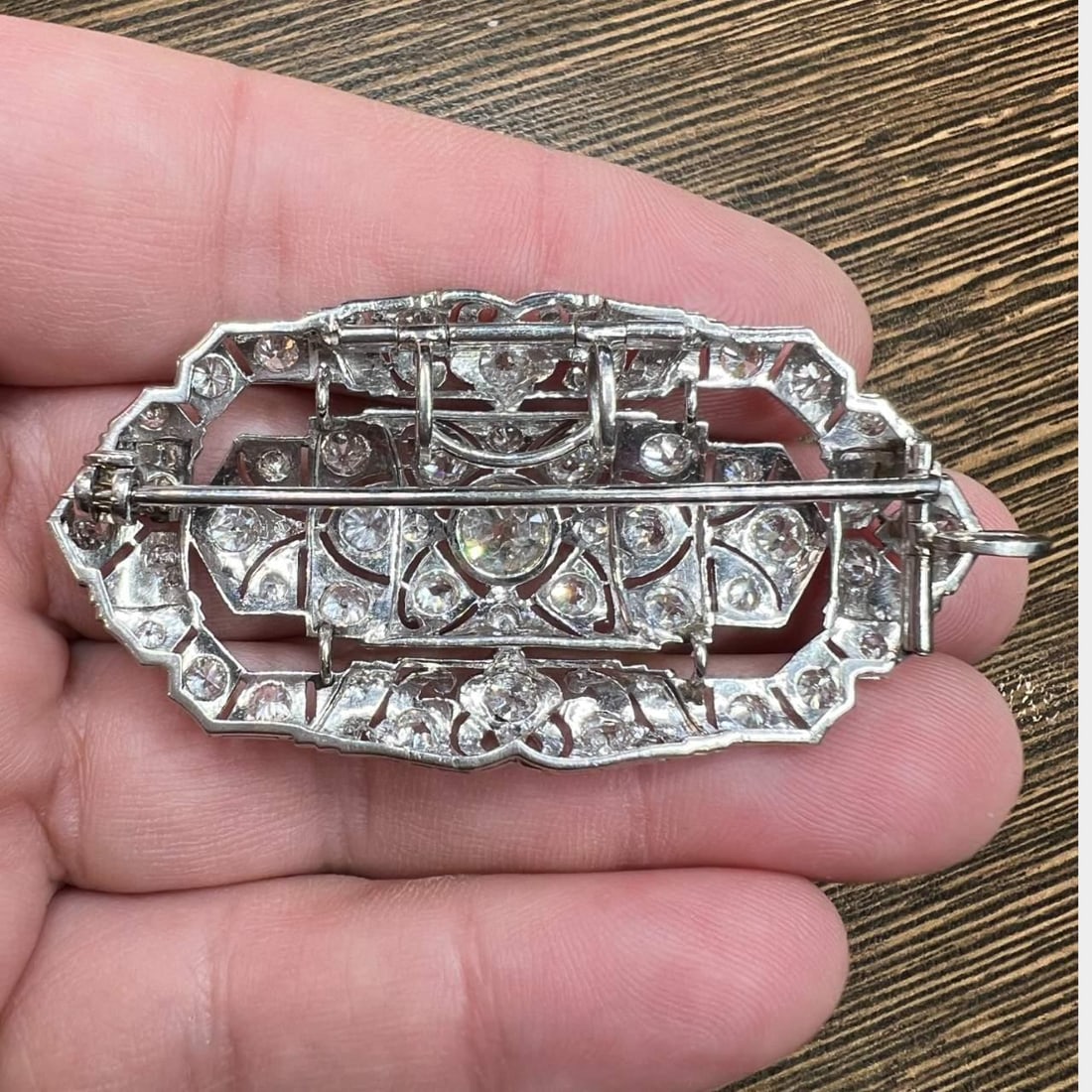 Art Deco Platinum Brooch 5.40 Ct. Diamond Center Stone: Art Deco Platinum Brooch 5.40 Ct. Diamond Center Stone This stunning Art Deco brooch is crafted from platinum and features a central diamond weighing approximately 1.40 Ct., exhibiting a J-K color